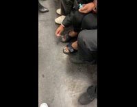 Woman paints toenails blue on train 
