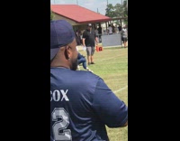 Little boy blocks and pushes opponent during football game 
