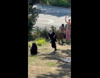 Woman nun outfit dances side of road