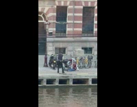 Guy jacket sit ground beside motorcycle river