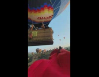 Woman red dress sit avoid hot air balloon