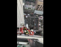 Two guys on window cleaning cart stuck sideways