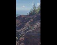 Man shirtless spins on the edge of a cliff