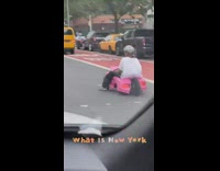White shirt guy rides pink toy car 