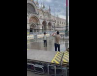 Man with afro hair poses on the flooded park  
