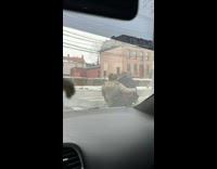 2 people drive on street in motorized shopping cart 