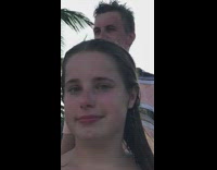Girl does yoga pose on beach sand 