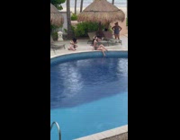Woman gray bikini sits on poolside photoshoot