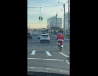 Collab WINY - Santa claus ride bike cross the intersection