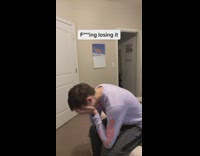 Guy long purple shirt shows himself sitting face in hands 