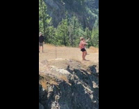 Two women raises hand with camera on timer behind