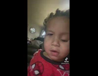 Mom wiping face of little boy in red shirt filter eyes