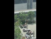 Woman in bikini bend over on the poolside bed