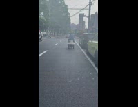 Man drives a three wheel scooter with chair
