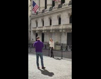 Woman white coat museum railings pillars flag