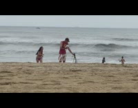Woman violet bikini run towards camera beach