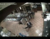Security cam of worker slipping in kitchen and then stretching it out