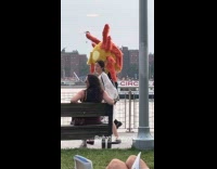 Man in suit walking with huge headdress