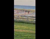 Woman blonde black bikini photo shoot beach