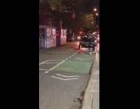 Guy hits boxes with golf club night time 