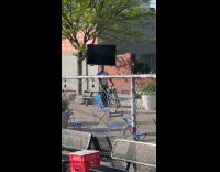 Guy rides bicycle balance TV on head