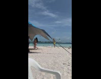 Man yellow shorts feeds the seagulls at the beach