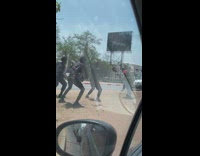 Three dancers black shirt dance roadside dirt