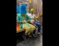 Collab Subway Creatures - Homer and Marge Simpson cosplayers ride train