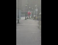 Mascot Walks Besides Man at River Bike Path