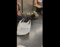 Man has black cat on leash