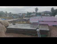 Heavy flood waters submerge the area and people on roof watch