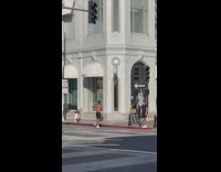 Man shirtless flexes his muscle on the sidewalk