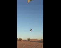 Man parasails off a truck in the desert and crashes into the sand