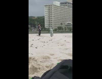 Woman green patterned raincoat dance beach music