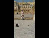 Woman in sports bra poses in front of golden gate