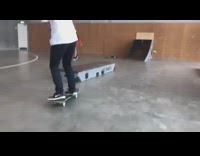 Collab ShredSlams - Skater grinds skateboard on block in indoor skatepark and falls on the ground
