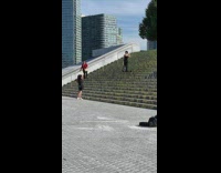 Black jumpsuit girl poses green stairs 