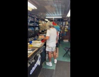 Man inside store with parrot on shoulder