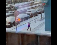 Woman jogs while it is snowing 
