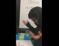 Guy sings about taking a test in math class, holding SAT book