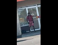 Man dance outside dunkin donuts store entrance