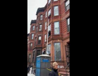 Guys pull up white object through window