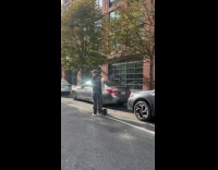 Man at street with baguette on backpack