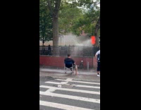Man sits in front of fire hydrant