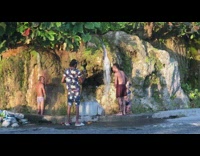 Three people shower small waterfalls music video shoot