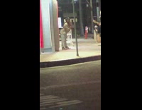 Woman cap grey leggings beside atm car