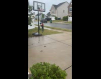 Boy plays basketball shoots from back ring
