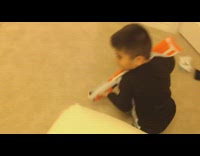 Little boy pretends to shoot girl toy