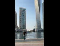 Guy black shirt set tripod twisted building