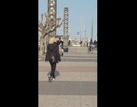 Lady takes selfie with ball sculpture 